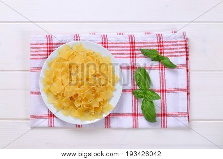 plate of quadretti - square shaped pasta on checkered dishtowel