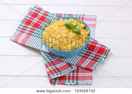 bowl of quadretti - square shaped pasta on checkered place mat