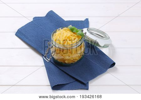 jar of quadretti - square shaped pasta on blue place mat