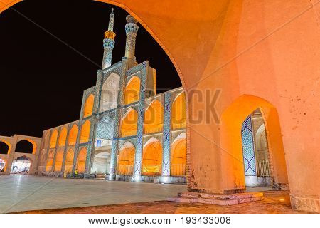 YAZD, IRAN - MAY 5, 2015: People socializing at the famous promenade in front of the Amir Chakhmaq scenic Complex in old city by night. Long exposition.