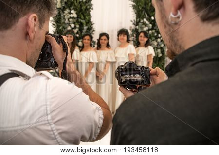 two photographers are shooting on the camera of the paparazzi on holiday