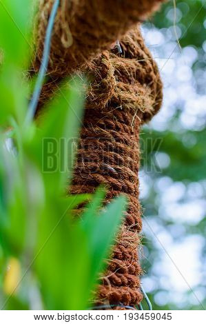 Garden decor column with winding brown string.