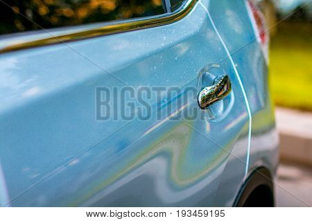 White Car with Silver Car Door Handle