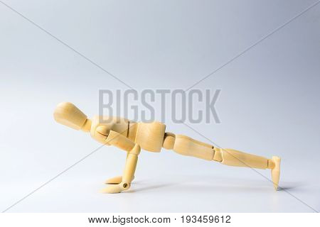 Wooden figure doll with push up for health on white for exercise training and helth concept.