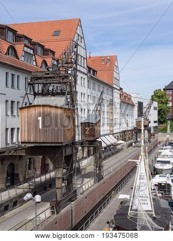 BERLIN GERMANY - JUNE 21 2017: Old Wooden Cranes And Boats In Tempelhofer Hafen Meaning Harbor of Tempelhof In German Language In Berlin