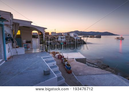 KIMOLOS, GREECE - MAY 23, 2017: Boat houses in fishing village of Goupa on Kimolos island in Greece on May 23, 2017.
