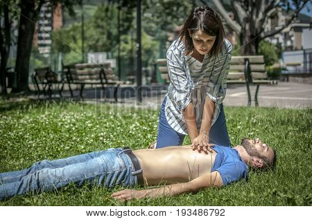 girl calling emergency service to assist a guy with cpr
