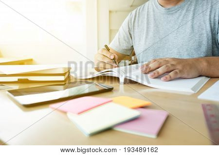 Close up of studying student hands writing in book during lecture education students college of university Reading Learning and Exam. Education concept.