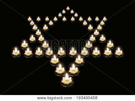 star of David from giridih candles on a black background. The concept of remembrance of the genocide of the Jews during the third Reich in Germany