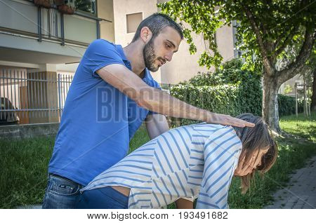 guy making the heimlich maneuver to a girl while she's chocking