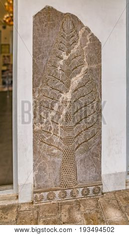 YAZD, IRAN - MAY 5, 2015: Pine tree carved in marble on display in museum inside the Zoroastrian Fire Temple Complex in old city.
