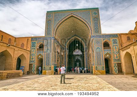 YAZD, IRAN - MAY 5, 2015: Group of tourists visiting the Yame mosque in old city.