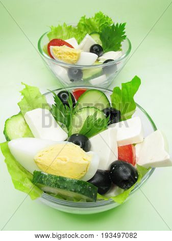two greek salads with cheese egg olive and tomato