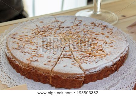 Traditional Italian Cream Cake with Powdered Sugar and Pine Nut