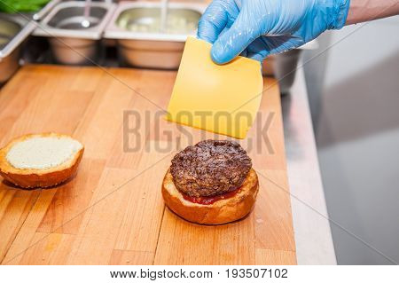 Chief Cook Preparing Fresh Burger In The Kitchen.burger Restaurant Menu Cooking Process. The Cook Pu