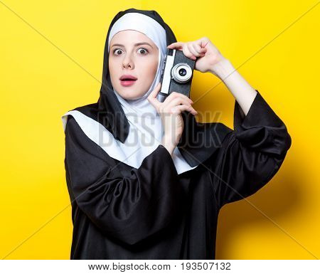 Young Surprised Nun With Vintage Photo Camera