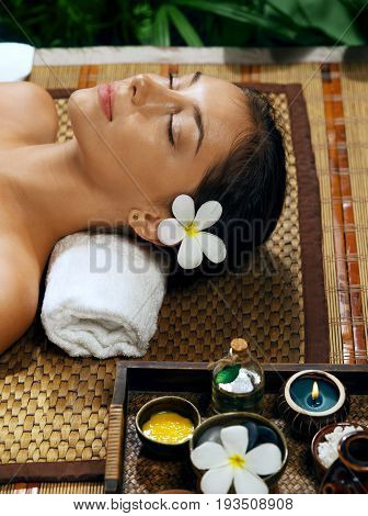portrait of young beautiful woman relaxing in spa environment