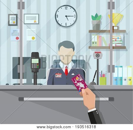 Bank teller behind window. Hand with bank card. Books, cup, plant, clocks, computer and keypad terminal. Depositing money in bank account. People service and payment. Vector illustration in flat style