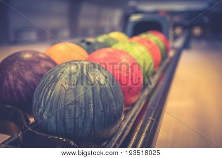 Bowling with colorful bowling balls in return machine