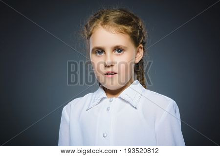 Closeup Portrait of little girl going surprise on gray background.