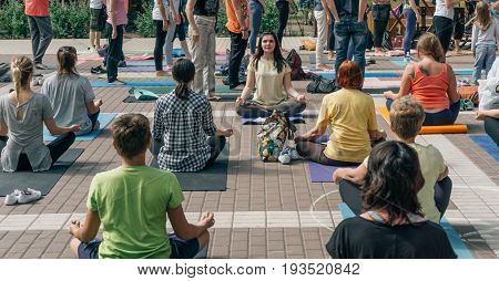 VORONEZH, RUSSIA - JUNE 18, 2017: Group of people are engaged in yoga in the Dynamo park on the International Yoga Day in Voronezh, Russia