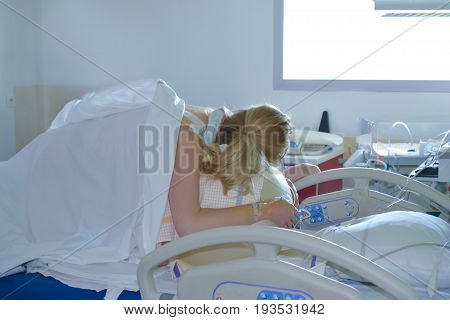 Woman during contractions on a fitness ball Parturition hospital