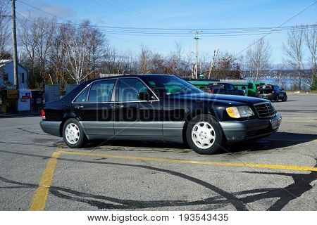 BAY VIEW, MICHIGAN / UNITED STATES - NOVEMBER 26, 2016: A black Mercedes-Benz S420 luxury sedan is parked in a strip mall parking lot.
