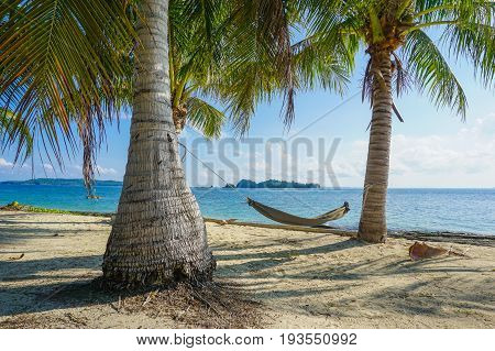 Hammock between palms trees at sandy beach in Rusukan besar island,Labuan Pearl of Borneo,Malaysia
