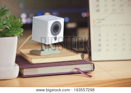 Security camera on Wood table. IP Camera.