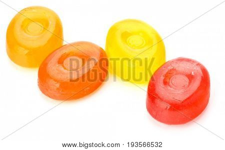 Four colorful fruit hard sugar candies,  boiled sweeties or sugar plums isolated on white background cutout