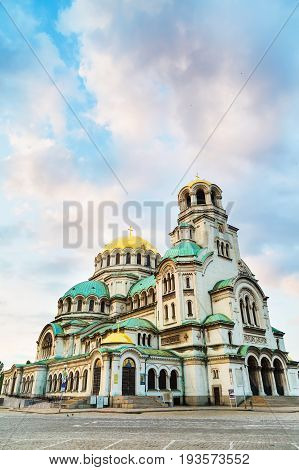 St. Alexander Nevsky Cathedral in the center of Sofia, capital of Bulgaria against the blue morning sky with colorful clouds