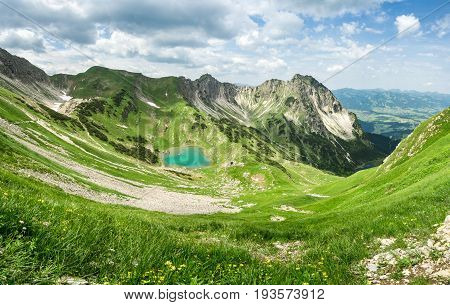 Remote Gaisalpsee lake up high in the alpine mountains in spring or summer. Bavaria, Allgau, Germany.