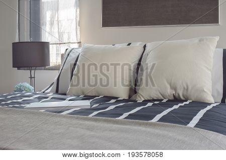 Offwhite And Striped Pillows On Bed With Deep Blue Striped Blanket In Modern Style Bedroom
