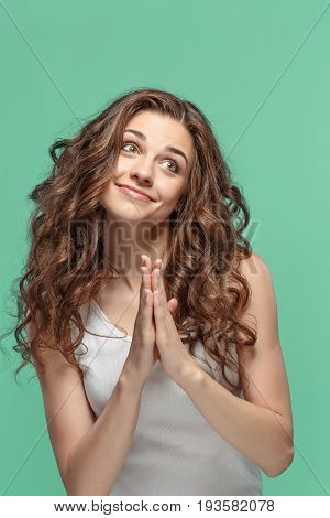 The Woman is looking imploring over gray studio background