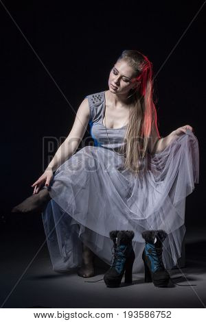 Actress In A Grey Dress On A Dark Stage