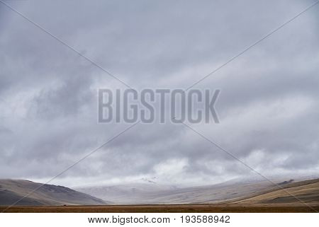 Autumn landscape of Altay. Sunset in the steppe beautiful evening sky with clouds plato Ukok no one around Altai Siberia Russia