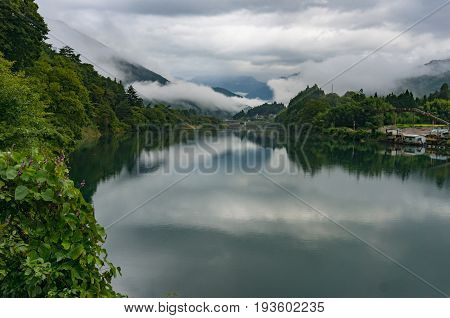 Mountain River Landscape In The Morning With Low Clouds And Fog