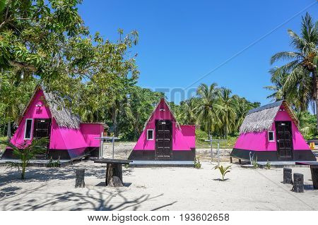 Labuan,Malaysia-May 1,2017:Colourful resort chalets with beautiful sandy beach at Rusukan Besar island in Labuan,Malaysia.It is a popular place for tourist to visit & snorkeling underwater in Labuan