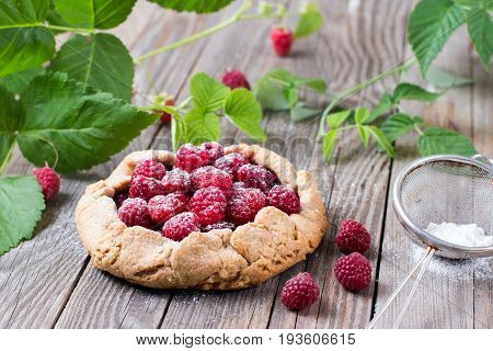 Summer delicious dessert blueberry galette on a wooden background