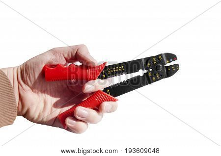 Hand holding red and black equipment plastic and metal cutter pilers for electrical cable