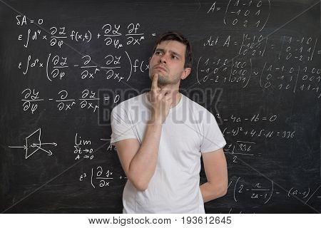 Young Student Is Thinking And Solving Mathematical Problem. Math