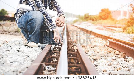 Railroad workers hold blue pint and white helmet checking railways for civil and construction site. Engineer Concep