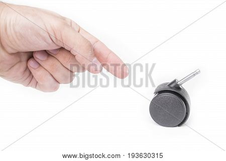 Hand points to a plastic furniture wheel isolated on a white background