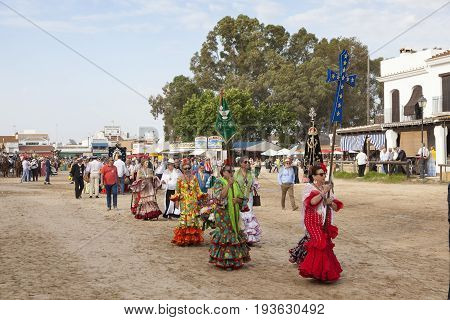 El Rocio Spain - June 2 2017: Procession of piilgrims in traditional spanish dress in El Rocio during the Romeria 2017. Andalusia Spain