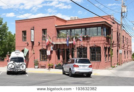 CODY, WYOMING - JUNE 24, 2017: The Chamberlin Inn. the historic hotel and landmark, has 21 units made up of a series of suites, rooms, cottage and garden studios.