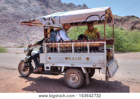 Hormuz Island Hormozgan Province Iran - 17 april 2017: Tourists make a tour of the island's natural attractions in a three-wheeled motobike van.