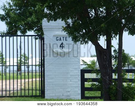Gate 4 entry to a large working quarter horse ranch. The gatepost are classic horse ranch be it Kentucky, New York or Texas.