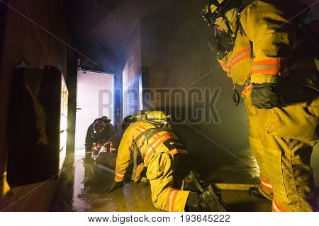 Firefighter Training Exiting The Building With A Victim