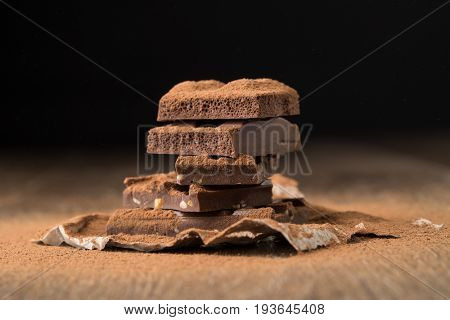 Milk chocolate on wooden table
