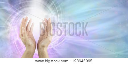 Channeling Vortex healing energy  - female hands reaching up with white vortex energy formation and pink blue ethereal energy field  background